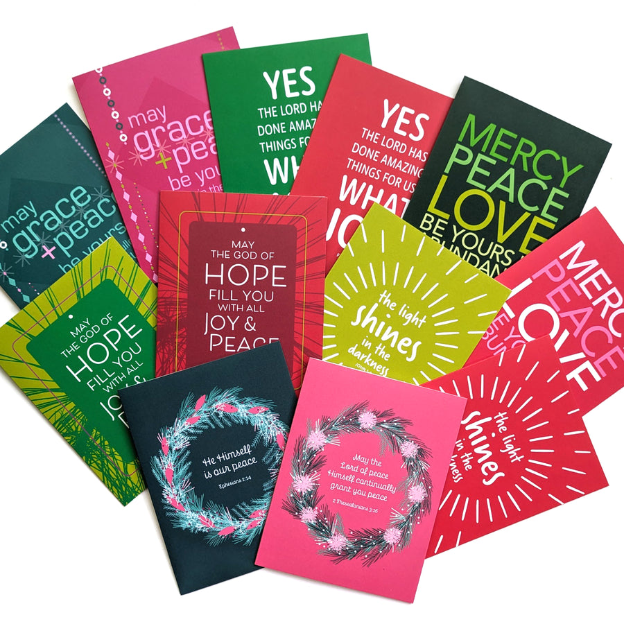 A collection of Bible verse Christmas cards spread out.