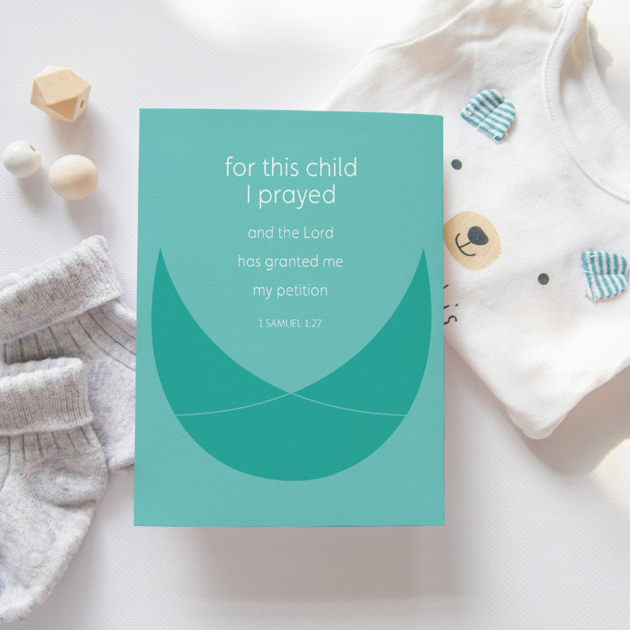 Bible verse for new babies 1 Samuel 1:27 for this child I prayed and the Lord has granted me my petition. Christian greeting card shown with onesie and baby socks.