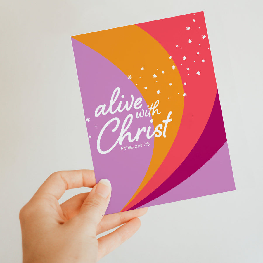 Hand holding Bible verse greeting card with Ephesians 2:5 