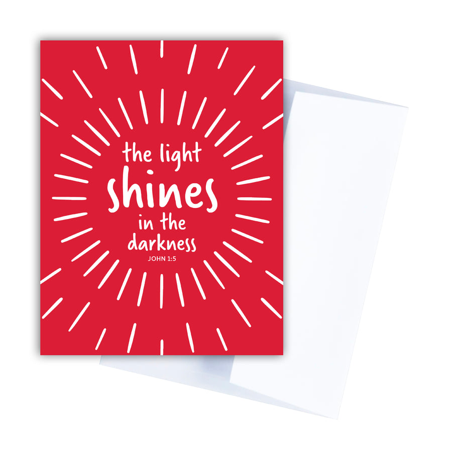Bright red Bible verse Christmas card with John 1:5. The light shines in the darkness.