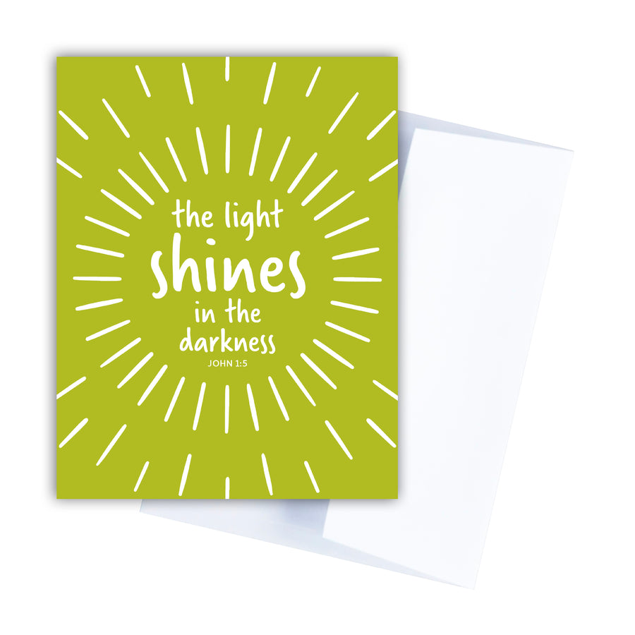 Lime green religious Christmas card with John 1:5. The light shines in the darkness.