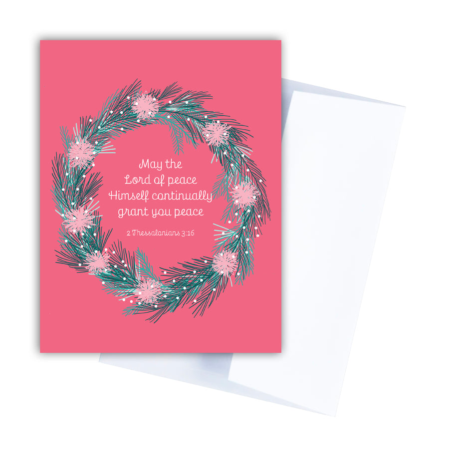 Pink Bible verse Christmas card with a wreath encircling 2 Thessalonians 3:16 May the Lord of peace Himself continually grant you peace.