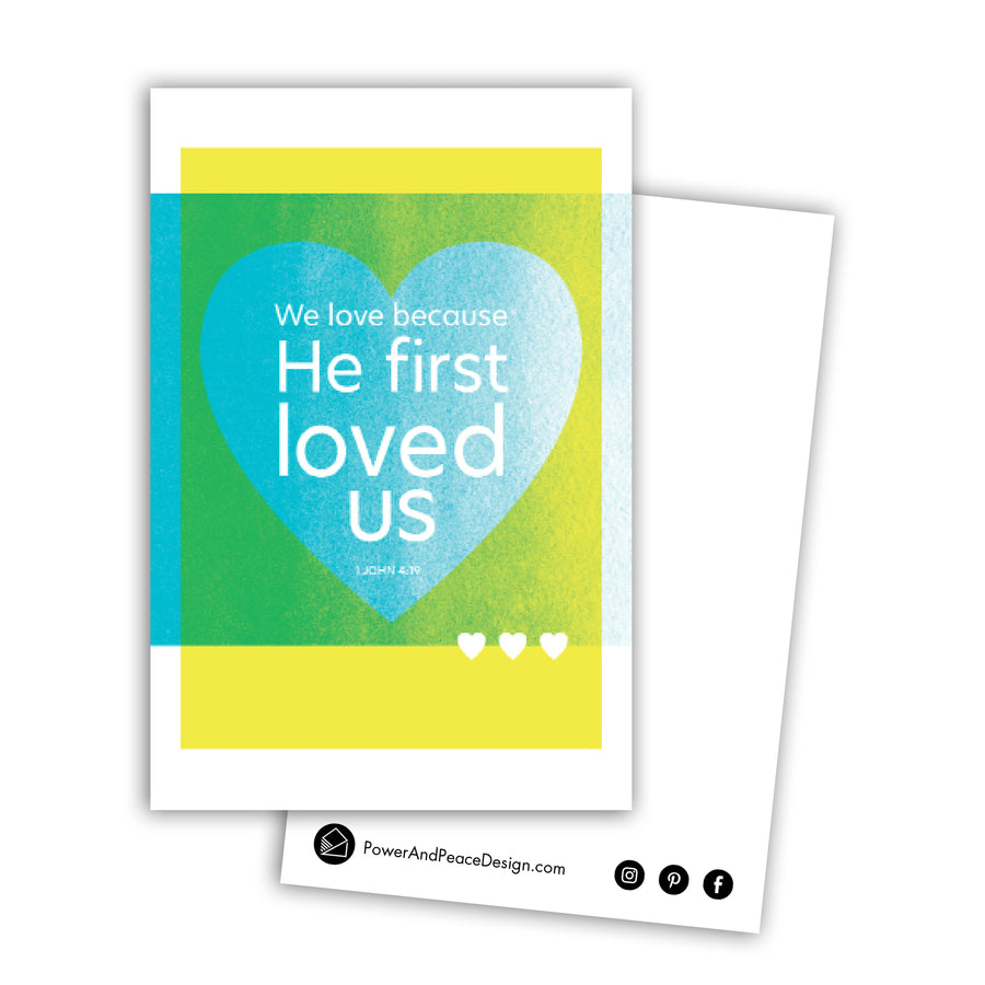 Bright yellow and teal Bible art postcard. We love because He first loved us. 1 John 4:19.