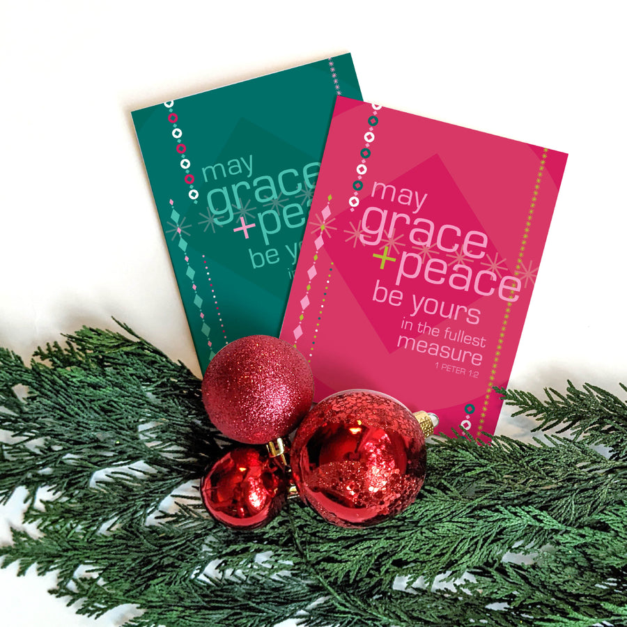 Two religious Christmas cards featuring 1 Peter 1:2 greeting: May grace and peace be yours in the fullest measure. Evergreen branch and red ornaments lay across bottom of image.