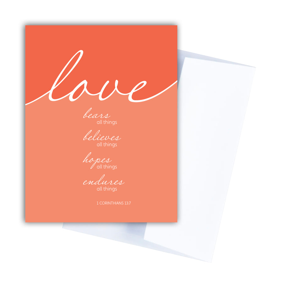 Coral Christian greeting card. Love bears all things, believes all things, hopes all things, endures all things. 1 Corinthians 13:7. Notecard shown with white envelope.