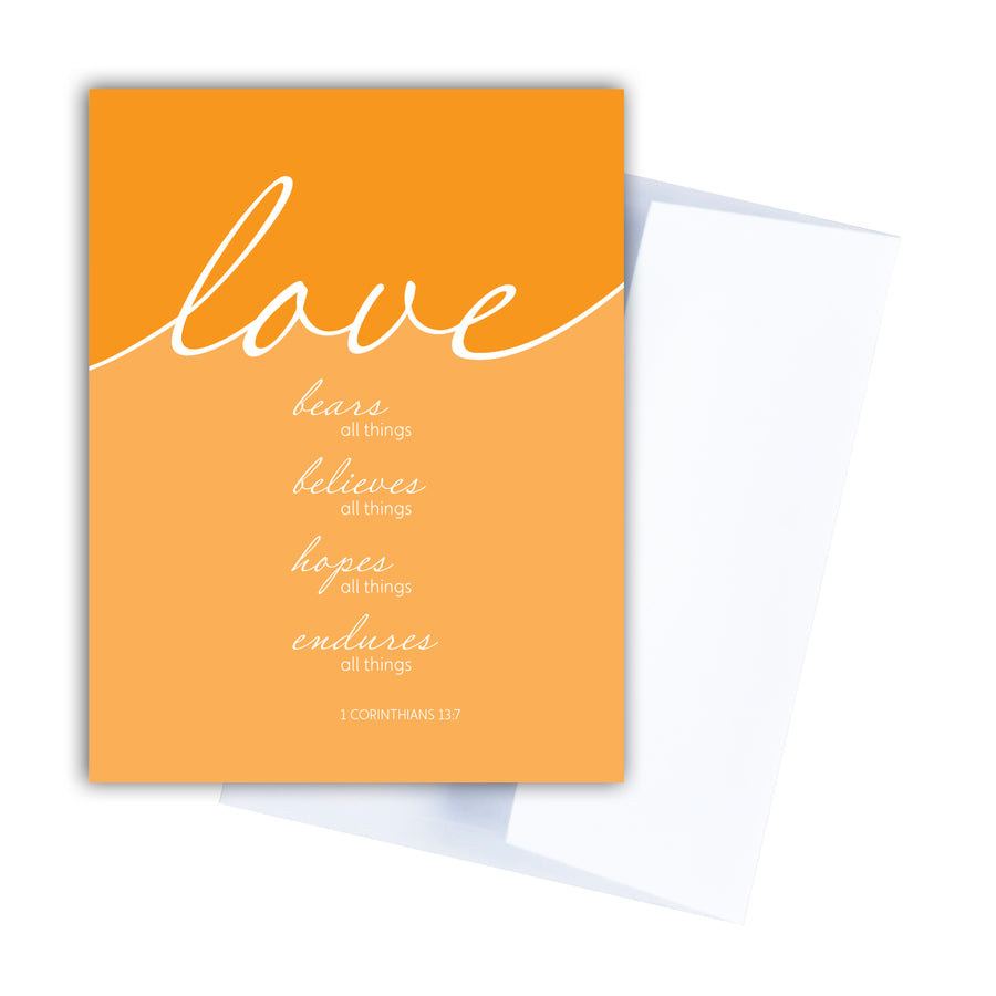 Mustard yellow Scripture greeting card. Love bears all things, believes all things, hopes all things, endures all things. 1 Corinthians 13:7. Greeting card shown with white envelope.