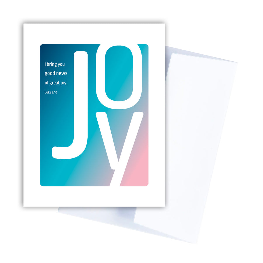 Christian baby card with Luke 2:10 I bring you good news of great joy! Large white letters spelling joy are arranged on a navy blue, teal, and pink ombre background.
