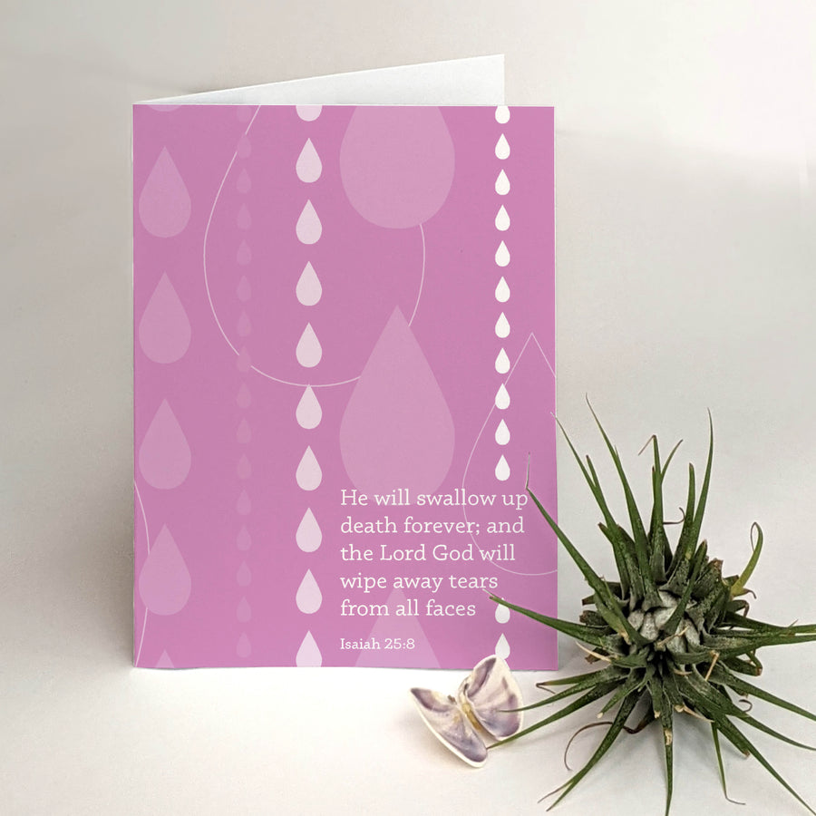 Open purple Christian sympathy card with text reading He will swallow up death forever; and the Lord God will wipe away tears from all faces Isaiah 25:8