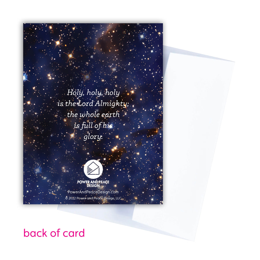 Back of Bible verse Christmas card reading Holy, holy, holy is the Lord Almighty; the whole earth is full of his glory. Power and Peace Design logo in white centered beneath the text. Background of card is a photo of outer space.