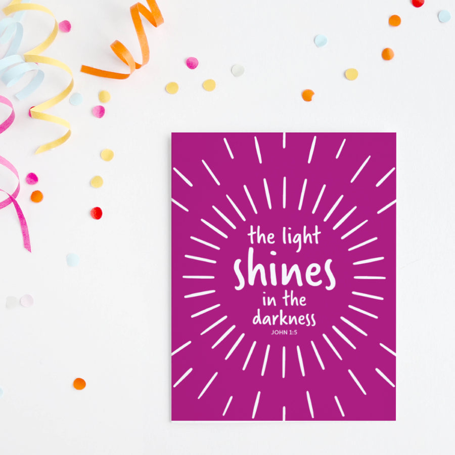 Colorful Christian greeting card with John 1:5 the light shines in the darkness.