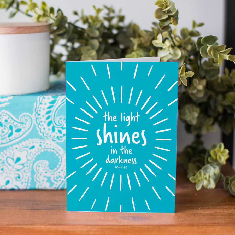 John 1:5 Bible verse greeting card. The light shines in the darkness.