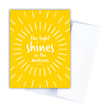 Yellow Christian encouragement greeting card with John 1:5 the light shines in the darkness.