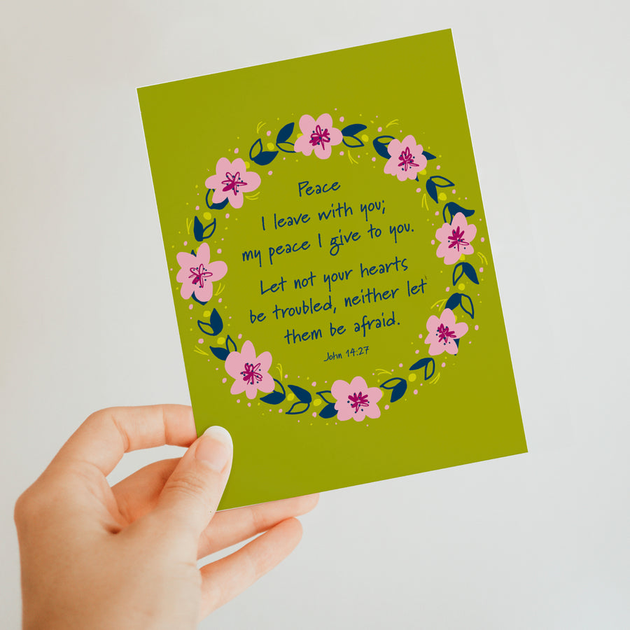Hand holding a brightly colored Christian encouragement greeting card. Text reads 