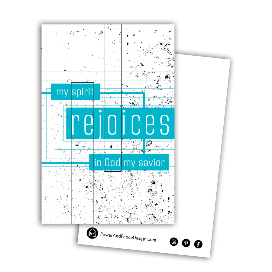 Postcard featuring the words my spirit rejoices in God my savior. Luke 1:47. Front of postcard is white with black paint splatters. The text is white on teal rectangles that are connected by lines. Power and Peace Design logo and website on back of postcard.