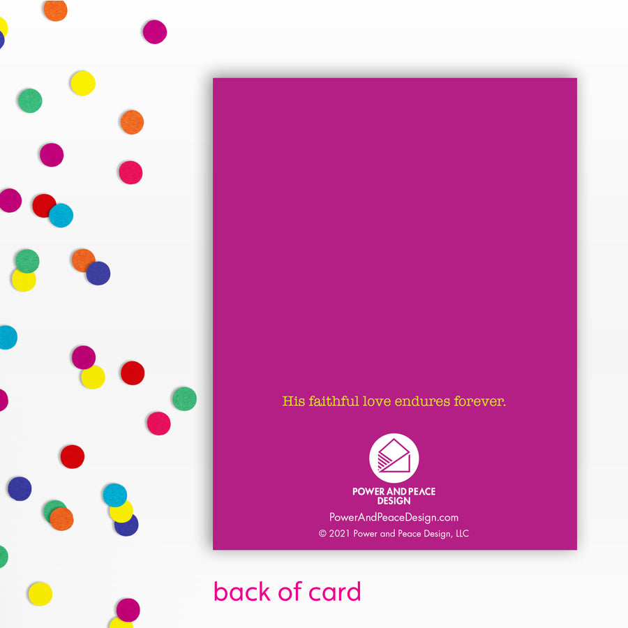 Back of fuchsia Christian greeting card reading: His faithful love endures forever. Sprinkle of confetti to left of card.