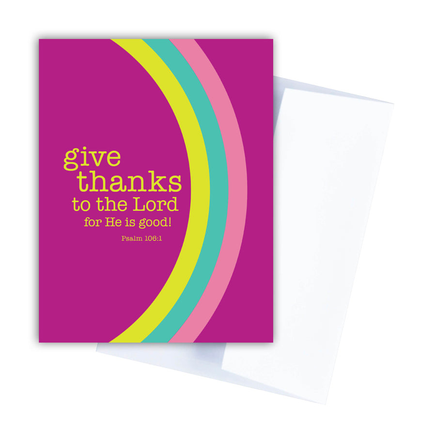 Fuchsia pink Christian birthday card with Psalm 106:1 give thanks to the Lord for He is good! Curving rainbow with pink, seafoam, and neon yellow hugs the card. White envelope shown behind it.