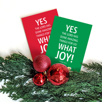 Red and green religious Christmas cards with Christian typography. Text on front of card reads 