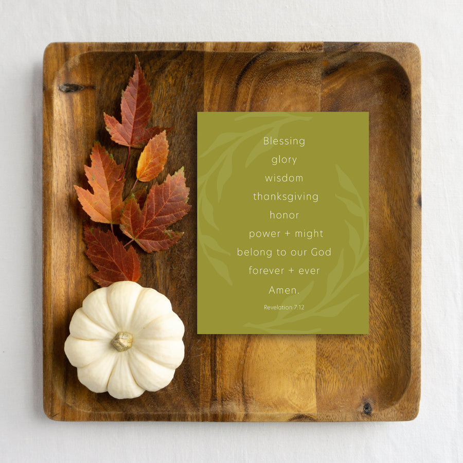 Wooden tray with olive green Bible verse Thanksgiving card, white pumpkin, and autumn leaves.