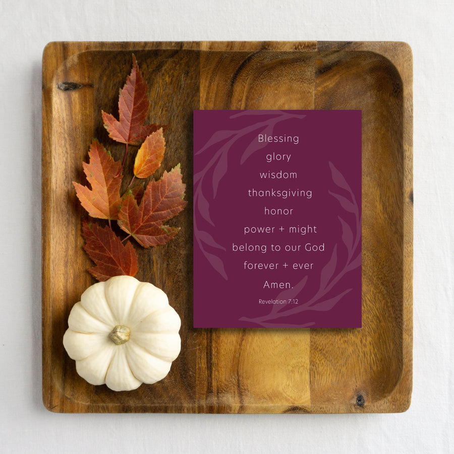 Purple Bible verse Thanksgiving card shown on wood tray with autumn leaves and white pumpkin. 