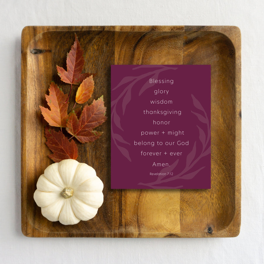 Wine Thanksgiving card reading Blessing, glory, wisdom, thanksgiving, honor, power and might belong to our God forever and ever. Amen. Revelation 7:12. Bible greeting card is laying on wood tray with autumn leaves and white pumpkin. 