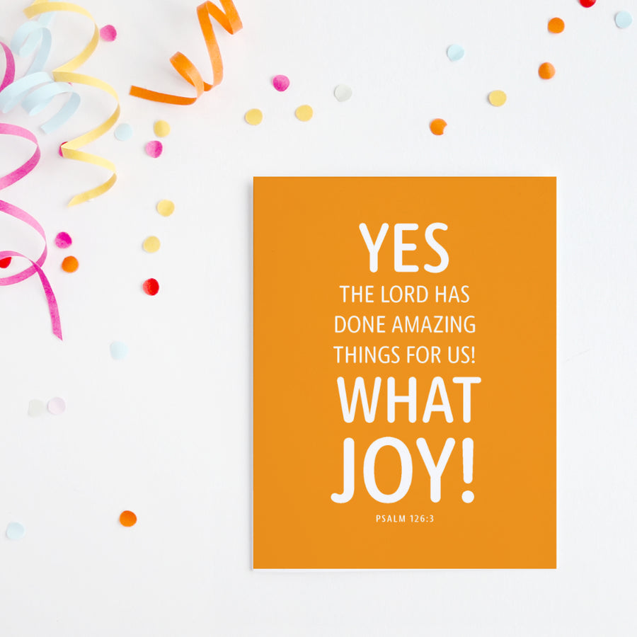 Yellow birthday card with Bible verse from Psalm 126:3. Yes, the Lord has done amazing things for us! What joy! Psalm 126:3. Confetti and ribbon in the upper corner of image.